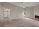 A bright living room features a fireplace, large windows, and a ceiling fan for added comfort at 5042 S Rainbow Blvd # 206, Las Vegas, NV 89118