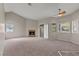 A bright living room features a fireplace, large windows, and a ceiling fan for added comfort at 5042 S Rainbow Blvd # 206, Las Vegas, NV 89118