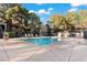 A refreshing community pool with lounge chairs for relaxing under the clear blue skies at 5042 S Rainbow Blvd # 206, Las Vegas, NV 89118