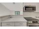 Updated kitchen featuring quartz countertops and new stainless steel appliances and breakfast bar at 5161 Lindell Rd # 206, Las Vegas, NV 89118