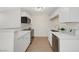 Bright kitchenette features white cabinets, stone countertops, and stainless steel appliances at 5161 Lindell Rd # 206, Las Vegas, NV 89118