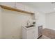 Bright kitchenette area with white cabinetry, stone countertops, and stainless steel dishwasher at 5161 Lindell Rd # 206, Las Vegas, NV 89118
