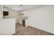 This kitchenette features bright white cabinets, stainless steel appliances, and wood look flooring at 5161 Lindell Rd # 206, Las Vegas, NV 89118