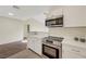 Contemporary kitchenette featuring stone counters, stainless steel oven, and light wood floors at 5161 Lindell Rd # 206, Las Vegas, NV 89118
