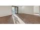 Bright living room featuring sliding glass doors to the balcony and plush carpeting at 5161 Lindell Rd # 206, Las Vegas, NV 89118