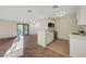 A cozy living room and adjacent modern kitchen with ample natural light and carpeted floors at 5161 Lindell Rd # 206, Las Vegas, NV 89118