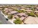 Expansive aerial view of a residential neighborhood featuring well-maintained homes with tile roofs and mature landscaping at 5568 Table Top Ln, Las Vegas, NV 89135
