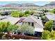 Community aerial view showcases desert landscaping, block fencing, mountain views, and nearby homes at 5568 Table Top Ln, Las Vegas, NV 89135