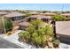 Spacious home with a well-manicured lawn, surrounded by lush trees, and a tile roof from an aerial vantage at 5568 Table Top Ln, Las Vegas, NV 89135