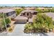 An aerial view showcases the front exterior, lush landscaping, well maintained lawn, and spacious driveway at 5568 Table Top Ln, Las Vegas, NV 89135