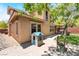 Spacious backyard features artificial grass, playset and covered patio, seamlessly blending relaxation and play at 5568 Table Top Ln, Las Vegas, NV 89135