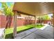 A covered patio flows into a lush, green backyard, creating a perfect blend of relaxation and outdoor fun at 5568 Table Top Ln, Las Vegas, NV 89135