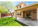 A covered patio extends the living space into the backyard, complete with a playset and lush artificial grass at 5568 Table Top Ln, Las Vegas, NV 89135