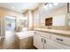 Bathroom featuring double sinks, a soaking tub, and access to a walk-in shower at 5568 Table Top Ln, Las Vegas, NV 89135
