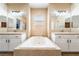 Bathroom showcasing a soaking tub situated between and vanity sinks at 5568 Table Top Ln, Las Vegas, NV 89135