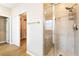 A stylish bathroom with a glass-enclosed shower and a view of the walk-in closet at 5568 Table Top Ln, Las Vegas, NV 89135