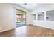 Bedroom with sliding doors to covered patio, wood floors, and large windows at 5568 Table Top Ln, Las Vegas, NV 89135