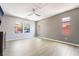 Spacious bedroom with wood floors, lots of natural light, and a contemporary ceiling fan at 5568 Table Top Ln, Las Vegas, NV 89135