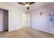 Carpeted bedroom with cute decorations, ceiling fan and closet at 5568 Table Top Ln, Las Vegas, NV 89135