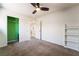 Carpeted bedroom featuring a lighted ceiling fan and closet, offering ample storage space at 5568 Table Top Ln, Las Vegas, NV 89135