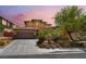 Charming two-story home featuring a terracotta roof, well-manicured landscaping, and an attached two-car garage at 5568 Table Top Ln, Las Vegas, NV 89135