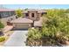 A well-manicured front yard and tile-roofed house offer a charming curb appeal for the property at 5568 Table Top Ln, Las Vegas, NV 89135