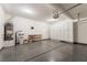 Spacious garage featuring epoxy flooring, ample storage cabinets and a water filtration system at 5568 Table Top Ln, Las Vegas, NV 89135