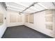 An empty two car garage showing windows with blinds, grey painted floors and white walls at 5568 Table Top Ln, Las Vegas, NV 89135