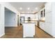 Modern kitchen with white cabinets, stainless steel appliances, and a spacious island with countertop seating at 5568 Table Top Ln, Las Vegas, NV 89135