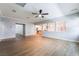 Spacious living room featuring wood floors, recessed lighting, and an open layout to the kitchen at 5568 Table Top Ln, Las Vegas, NV 89135