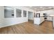 Open-concept living and kitchen area with white cabinets, stainless steel appliances, and a view of the living space at 5568 Table Top Ln, Las Vegas, NV 89135