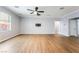 Spacious living room with wood floors, a ceiling fan and large windows which offer plenty of natural light at 5568 Table Top Ln, Las Vegas, NV 89135