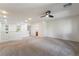 Spacious loft area with neutral carpet, a ceiling fan, and access to the upper level at 5568 Table Top Ln, Las Vegas, NV 89135