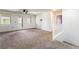 Upstairs loft featuring neutral carpet, bright light, and stairs to the lower level at 5568 Table Top Ln, Las Vegas, NV 89135
