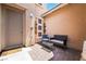 Enclosed courtyard area features a cozy seating arrangement on a brick patio with well-maintained stucco walls at 5568 Table Top Ln, Las Vegas, NV 89135