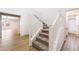 A bright staircase with carpeted steps and white railing leads up to the second floor of this stylish house at 5568 Table Top Ln, Las Vegas, NV 89135