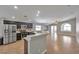 Open-concept kitchen with stainless steel appliances, dark cabinets, and views of the expansive living area at 5732 Hornbrook St, North Las Vegas, NV 89031