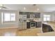 Bright kitchen with stainless steel appliances, dark cabinets, tile floors, and ample natural light at 5732 Hornbrook St, North Las Vegas, NV 89031