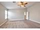 Large main bedroom with carpet. Features neutral wall paint and ceiling fan at 5732 Hornbrook St, North Las Vegas, NV 89031