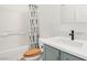 Bathroom with a tub and shower combination, a modern vanity, and wood-look flooring at 6313 Pangea Ave, Las Vegas, NV 89139