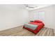 Cozy bedroom with a ceiling fan, wood-look floors, and natural light from the window at 6313 Pangea Ave, Las Vegas, NV 89139