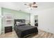 Cozy bedroom featuring a ceiling fan, wood-look floors, and bright natural light at 6313 Pangea Ave, Las Vegas, NV 89139