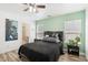 Bedroom featuring a ceiling fan, a bed with black covers, and a view of the bathroom at 6313 Pangea Ave, Las Vegas, NV 89139