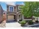 Charming two-story home with a quaint balcony, attached garage and well-manicured front yard at 6313 Pangea Ave, Las Vegas, NV 89139
