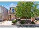 Inviting two-story home featuring a private balcony, driveway, mature landscaping, and a porte-cochere at 6313 Pangea Ave, Las Vegas, NV 89139