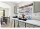 This kitchen boasts gray cabinets, modern countertops, and a sleek black sink beneath a window at 6313 Pangea Ave, Las Vegas, NV 89139