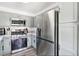 Well-equipped kitchen with stainless steel appliances, gray cabinets, and stone countertops at 6313 Pangea Ave, Las Vegas, NV 89139