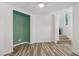 Bright living room with wood-look floors, ceiling fan, and open staircase at 6313 Pangea Ave, Las Vegas, NV 89139