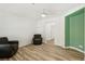 Bright living room with wood-look floors, ceiling fan, and cozy seating at 6313 Pangea Ave, Las Vegas, NV 89139