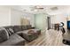 Spacious living room with a large sectional sofa, wood-style flooring, and a ceiling fan at 6313 Pangea Ave, Las Vegas, NV 89139